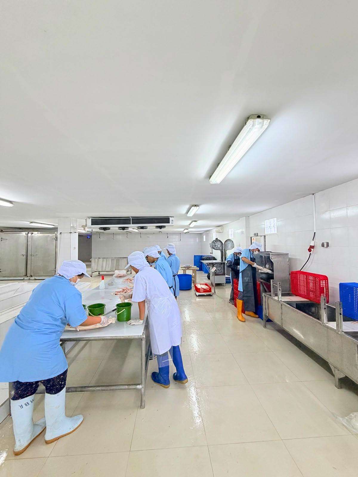 Team processing seafood in a clean facility
